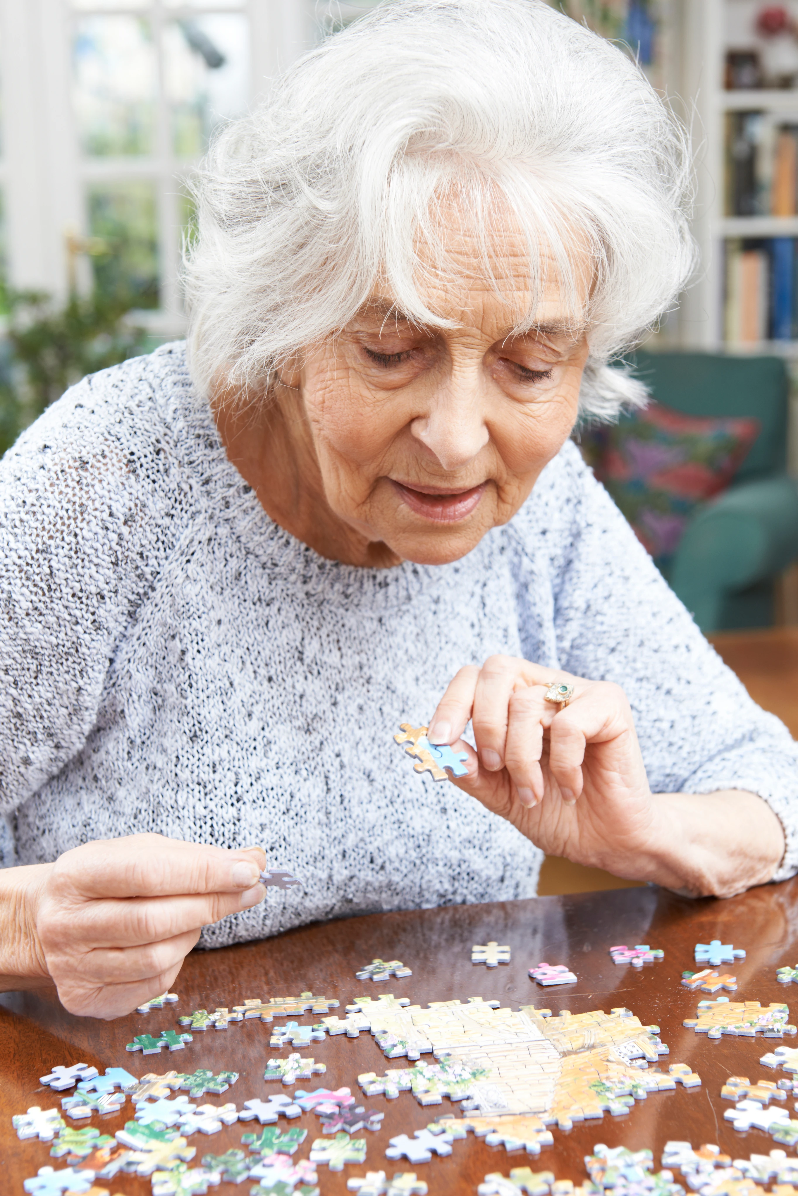 Elderly woman doing puzzle